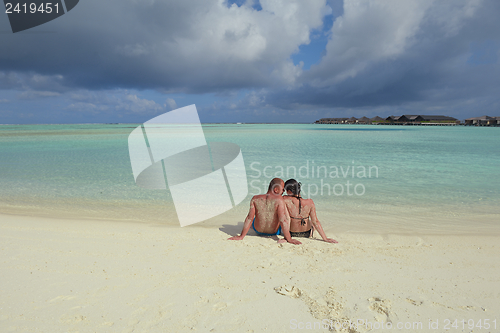 Image of happy young couple have fun on beach