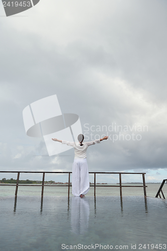 Image of young woman relax on cloudy summer day