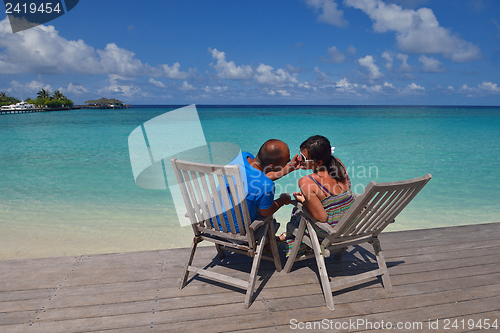 Image of happy young couple have fun on beach