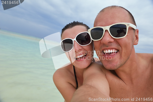 Image of happy young couple have fun on beach