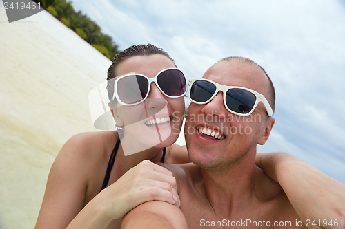 Image of happy young couple have fun on beach