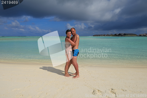 Image of happy young couple have fun on beach
