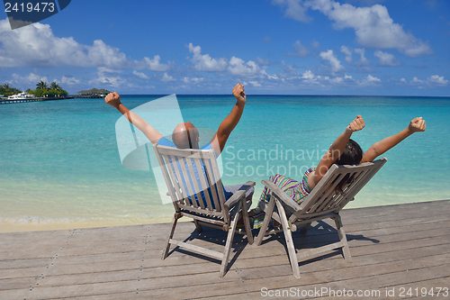 Image of happy young couple have fun on beach