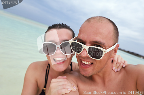 Image of happy young couple have fun on beach