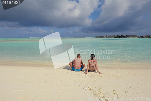 Image of happy young couple have fun on beach