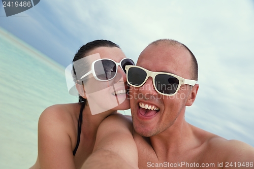 Image of happy young couple have fun on beach