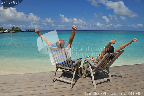 Image of happy young couple have fun on beach