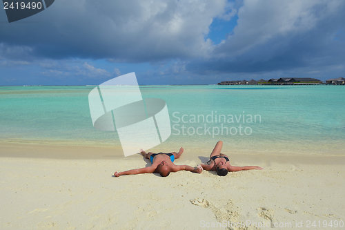 Image of happy young couple have fun on beach