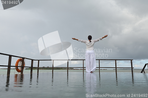 Image of young woman relax on cloudy summer day