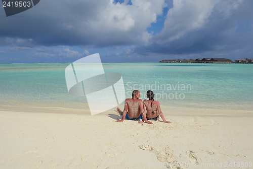 Image of happy young couple have fun on beach
