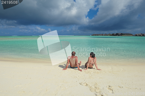 Image of happy young couple have fun on beach