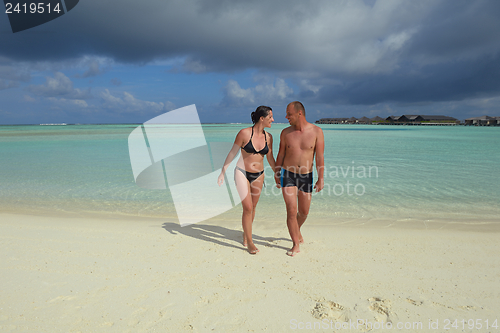 Image of happy young couple have fun on beach