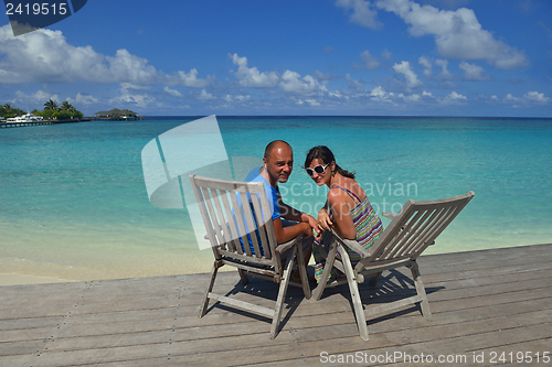 Image of happy young couple have fun on beach