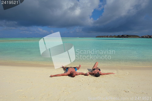 Image of happy young couple have fun on beach