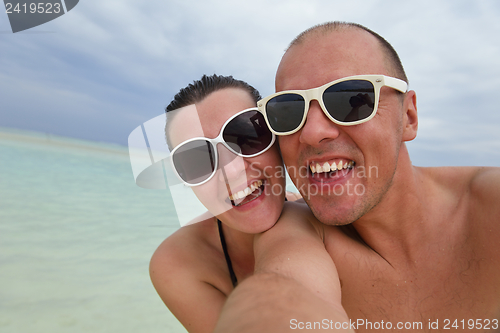 Image of happy young couple have fun on beach