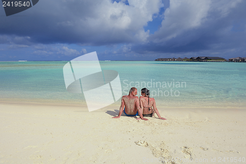Image of happy young couple have fun on beach