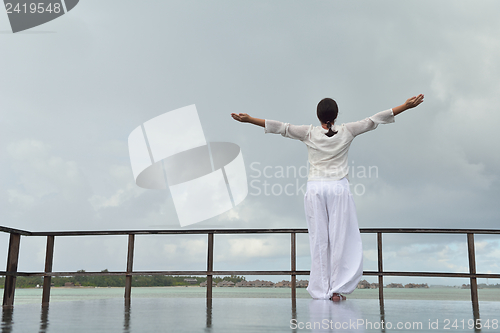 Image of young woman relax on cloudy summer day
