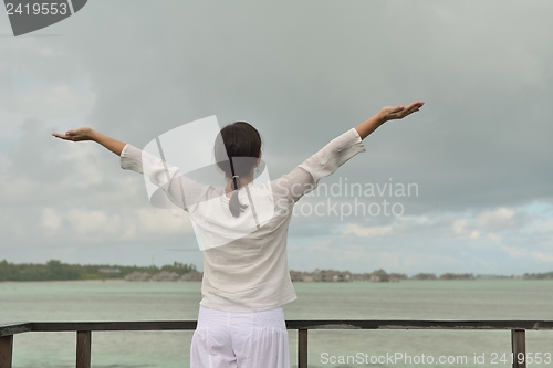 Image of young woman relax on cloudy summer day
