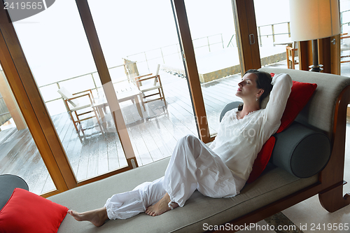 Image of happy young woman relax at home on sofa