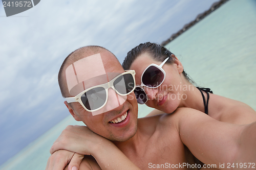 Image of happy young couple have fun on beach