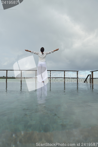 Image of young woman relax on cloudy summer day