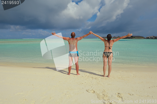 Image of happy young couple have fun on beach