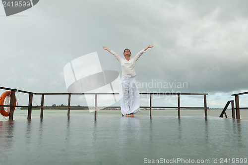 Image of young woman relax on cloudy summer day