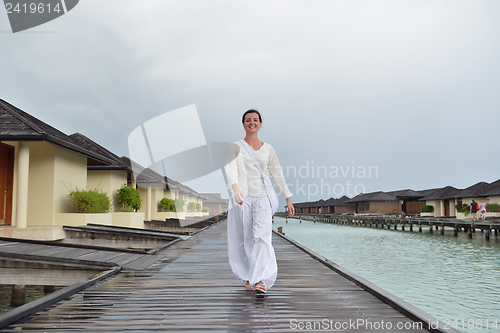 Image of young woman relax on cloudy summer day