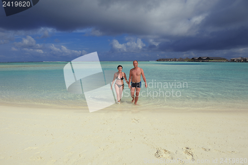 Image of happy young couple have fun on beach