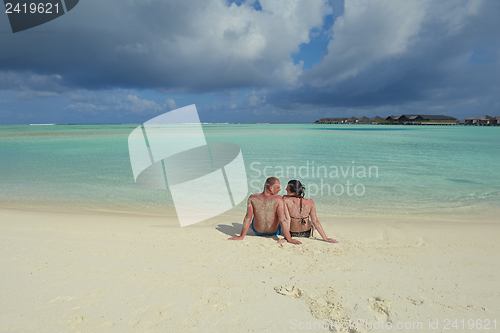 Image of happy young couple have fun on beach