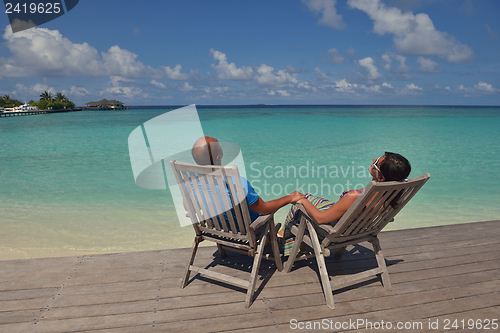 Image of happy young couple have fun on beach