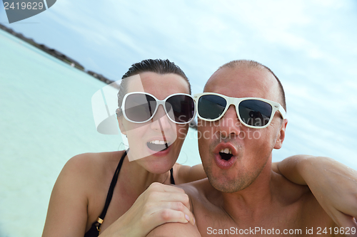 Image of happy young couple have fun on beach