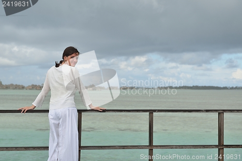 Image of young woman relax on cloudy summer day