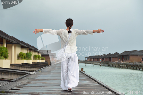 Image of young woman relax on cloudy summer day