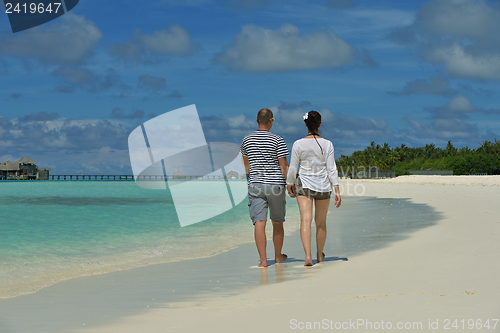 Image of happy young couple have fun on beach