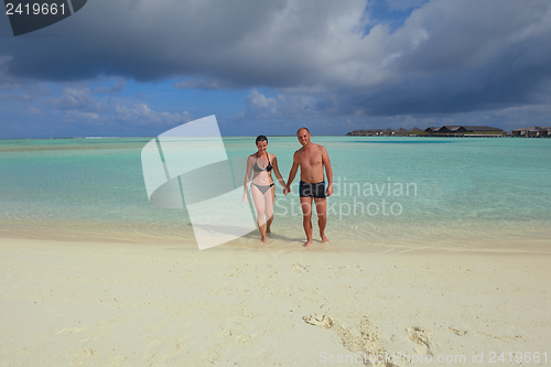 Image of happy young couple have fun on beach
