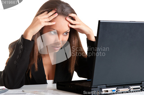 Image of Worried Woman Looking At A Computer Monitor