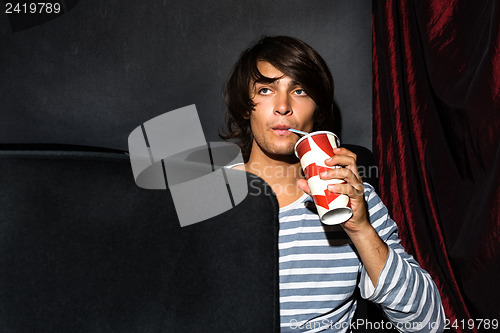 Image of Man Drinking Soda In Cinema Theatre