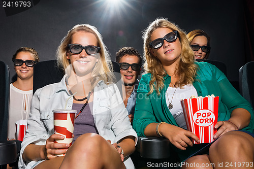 Image of Friends Watching 3D Movie In Theater