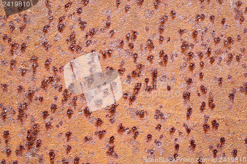 Image of brown rusty surface with bulges