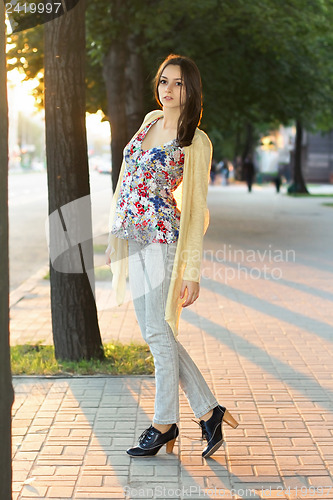 Image of Pretty brunette in grey jeans