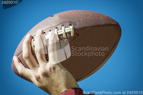 Image of hand with american football