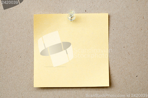 Image of yellow color note paper with pin