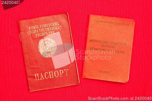 Image of party card  of CPSU and passport over red