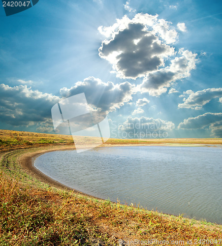 Image of pond under cloudy sky