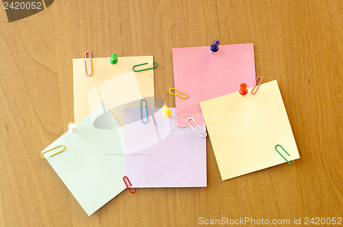 Image of five sticker notes with pins and clips