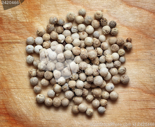 Image of white pepper macro on wooden board