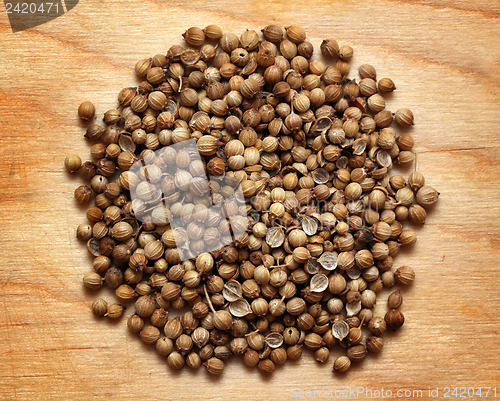 Image of seeds of coriander macro on wooden board