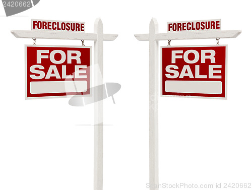 Image of Two Foreclosure For Sale Real Estate Signs with Clipping Path