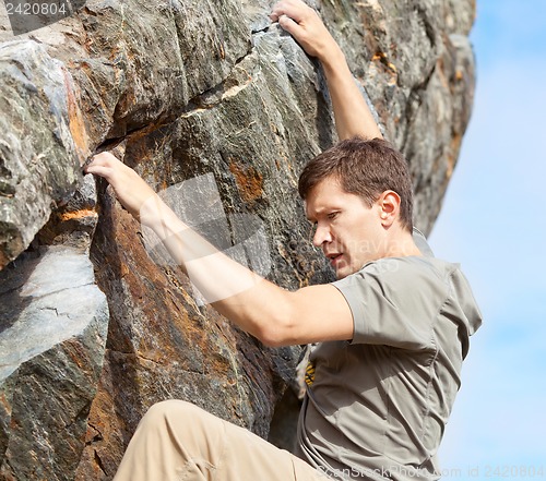 Image of man bouldering